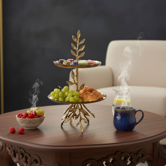 Two-tier stainless steel serving stand with decorative brass leaf accents.
