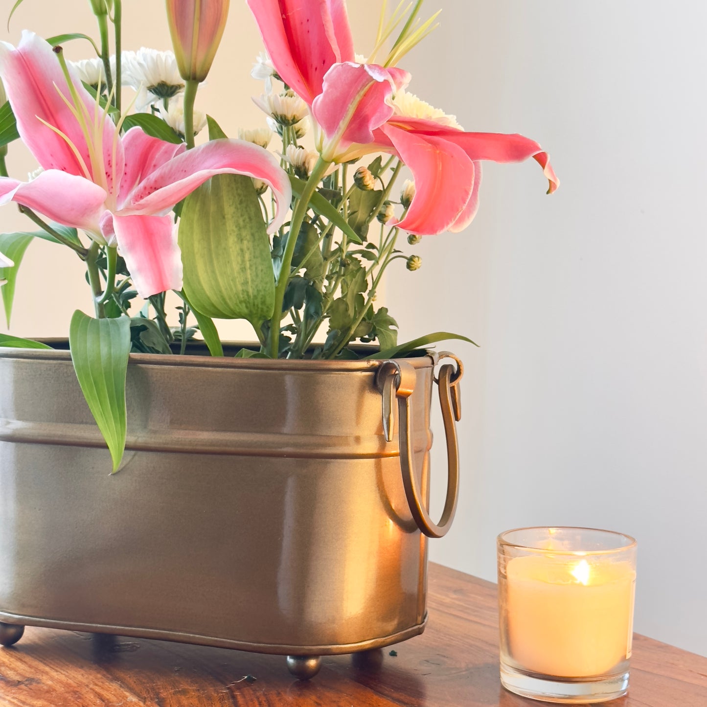 Handmade vintage brass metal indoor planter with floral arrangement, rectangular planter for elegant living room styling.