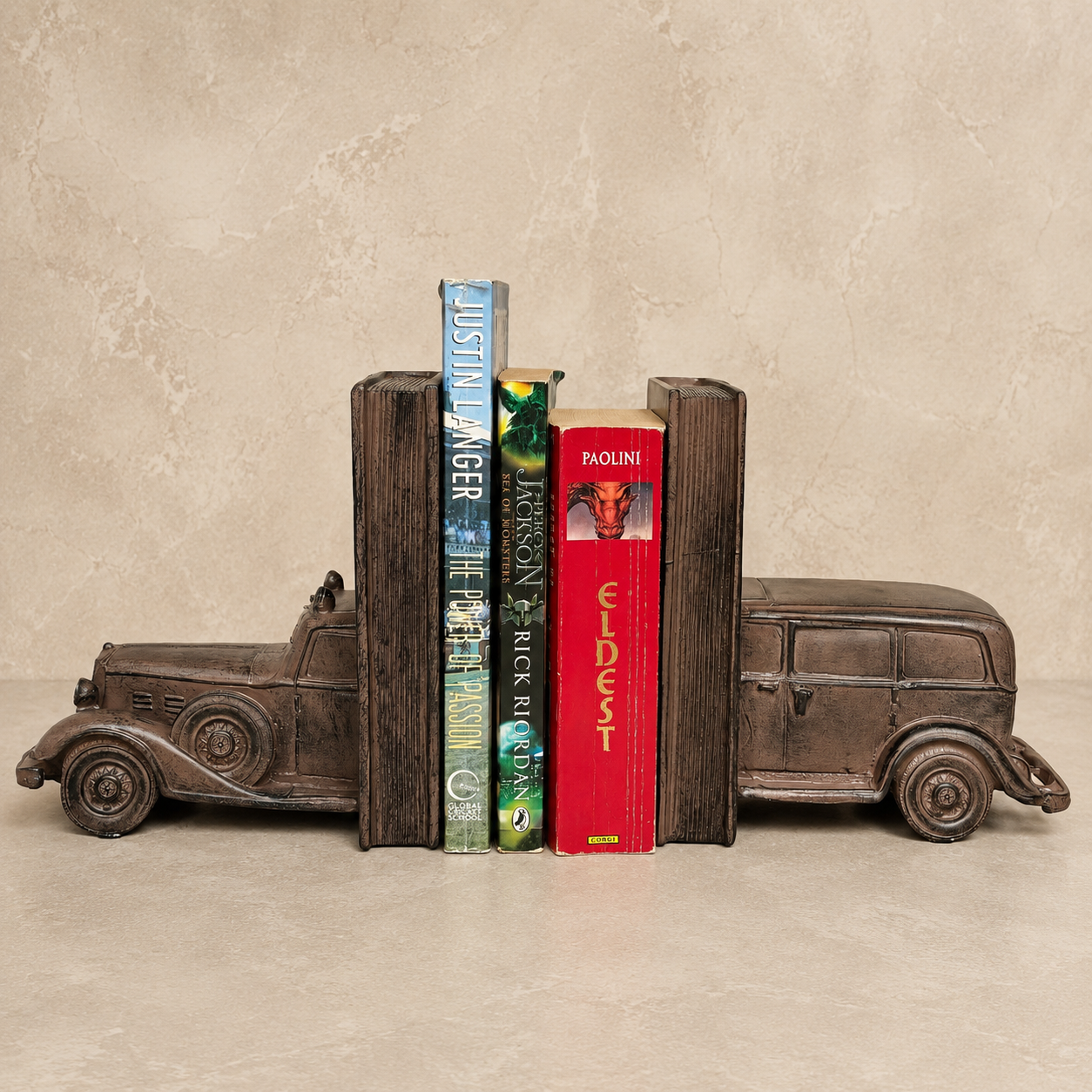 Vintage car bookends in an antique bronze finish holding books, handcrafted luxury decorative bookends for bookshelves, home office, study room, and living room décor.