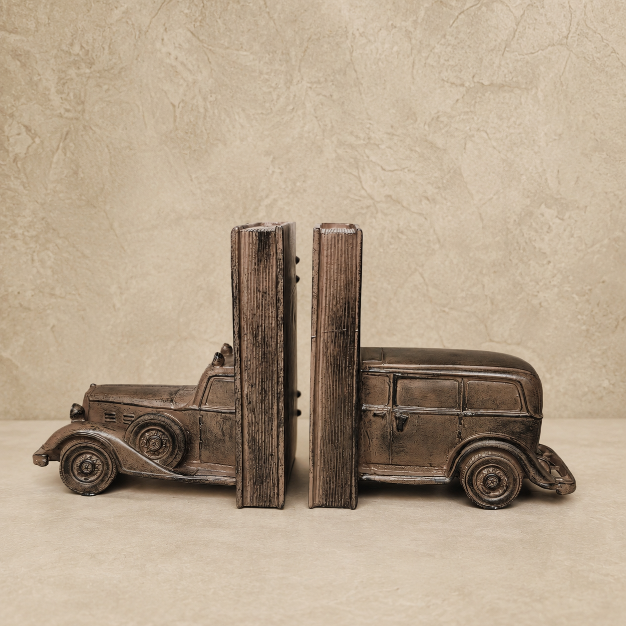 Side view of vintage antique car bookends in an antique bronze finish, showcasing the detailed classic automobile design and sturdy book support for luxury home office or library décor.