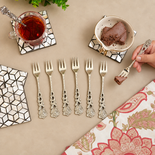 Vintage Floral Dessert Forks Set of 6 crafted from premium stainless steel with ornate floral handles, elegantly displayed in a flat lay with tea and dessert on a warm beige tabletop, perfect for serving cakes, pastries, and desserts.