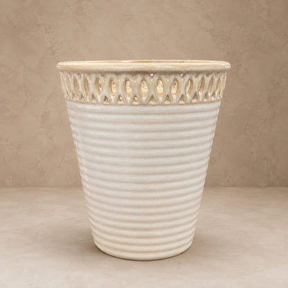 Front view of a cream glazed ceramic planter with decorative cutwork rim and ribbed texture for indoor and outdoor décor.