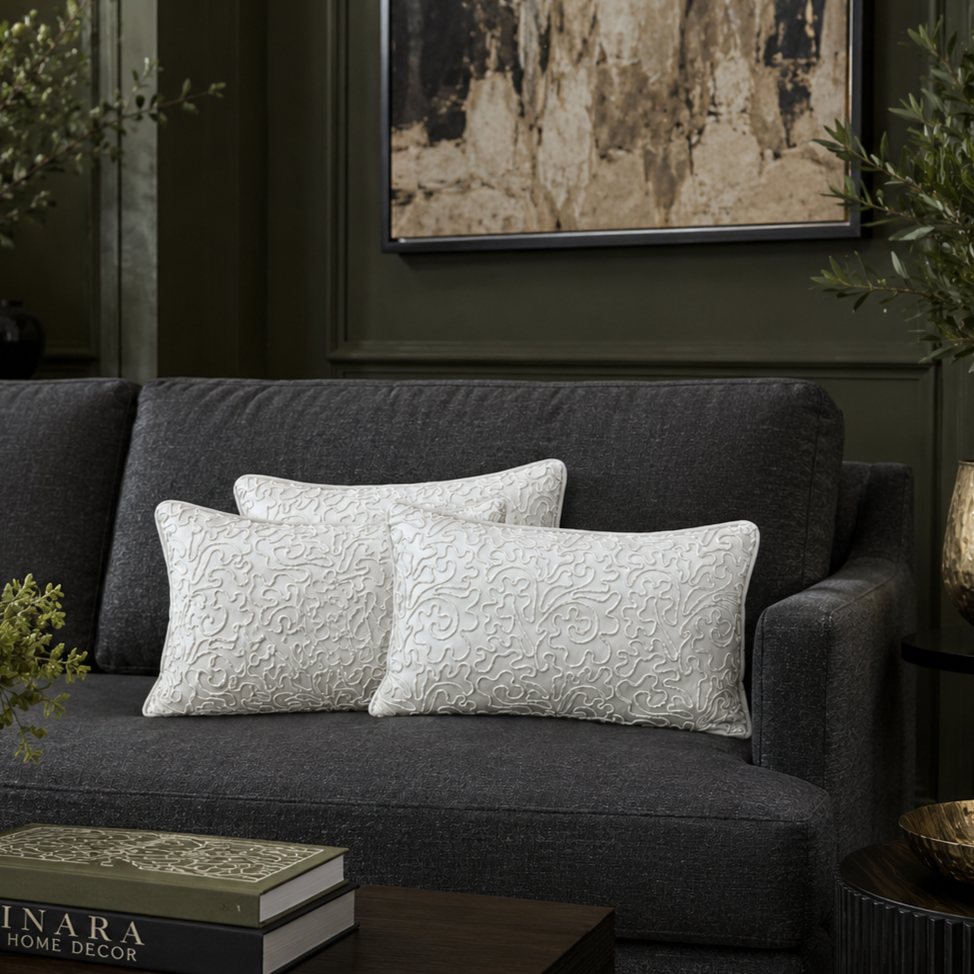 White embroidered velvet cushion covers 12x18 styled on a dark grey sofa in a luxury living room, showcasing elegant textured detailing and premium home décor styling.