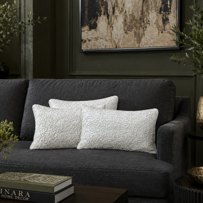 White embroidered velvet cushion covers 12x18 styled on a dark grey sofa in a luxury living room, showcasing elegant textured detailing and premium home décor styling.