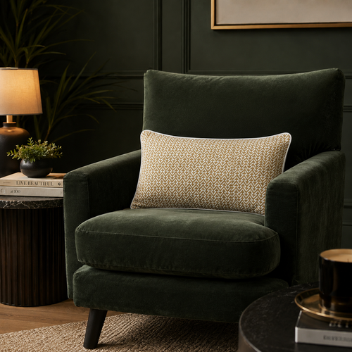 Mustard and white cotton silk lumbar cushion cover styled on a dark green premium accent chair in a luxury living room by Inara Home Decor.