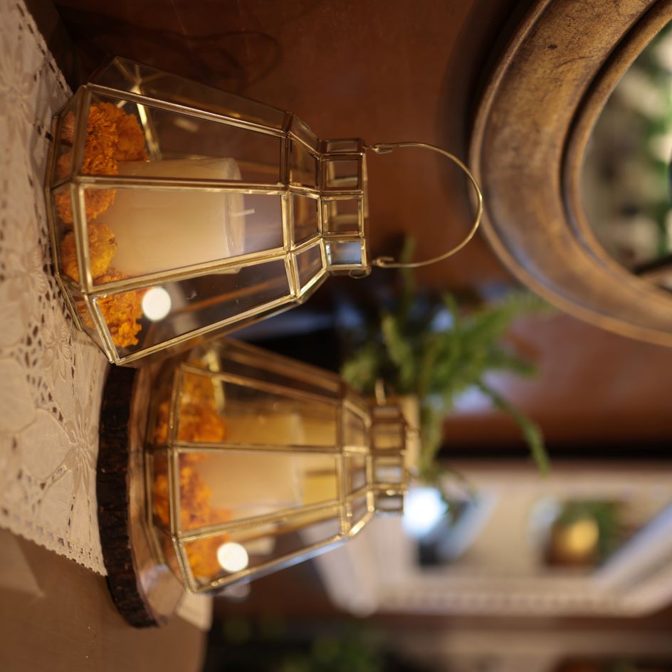 Handcrafted gold glass hanging lantern with a brass frame and a candle, a decorative Diwali lantern for festive home décor