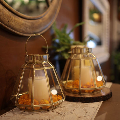 Handcrafted gold glass hanging lantern with a brass frame and a candle, a decorative Diwali lantern for festive home décor