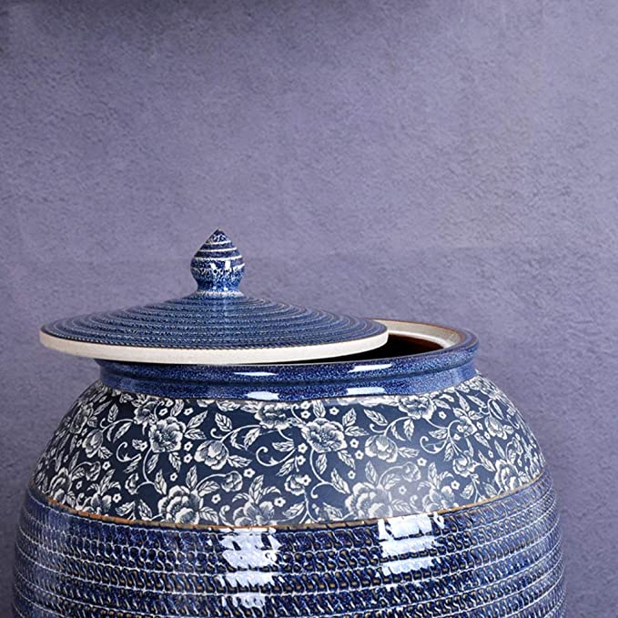 Side view of a premium blue ceramic decorative canister featuring a white floral border and a matching textured lid.