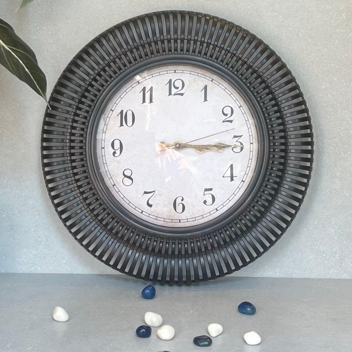Sunburst Clock Black – A stylized wall clock adds a touch of whimsy to your decor.Undeniably nostalgic and definitely charming | INARA